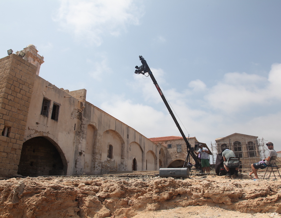 A still of a camera atop a crane filming the holy monastery of Apostolos Andreas in Cyprus.